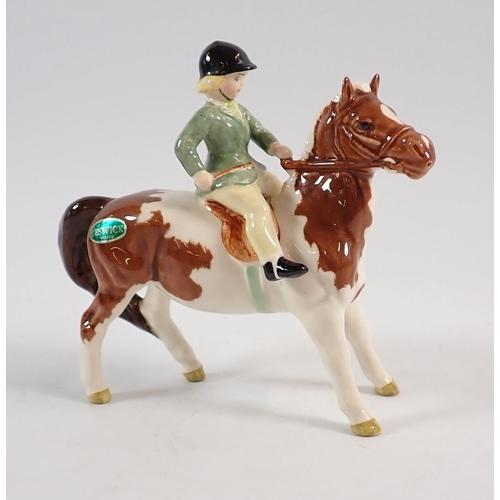 151 - A Beswick girl on Skewbald pony 14.5cm tall