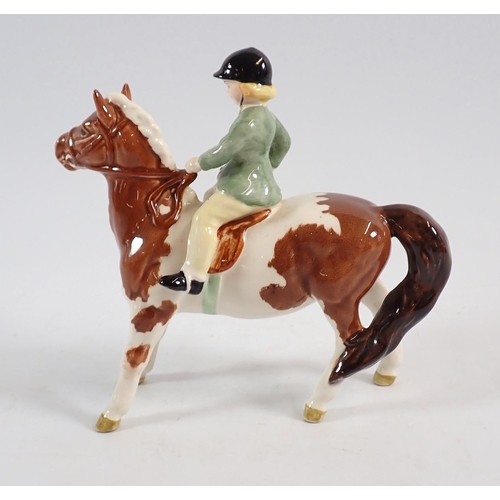 151 - A Beswick girl on Skewbald pony 14.5cm tall