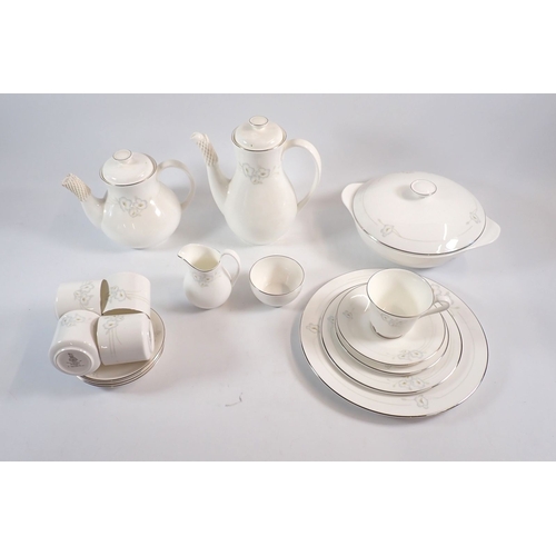 153 - A Royal Doulton comprehensive Mystique dinner service comprising eleven tea cups and twelve saucers,... 