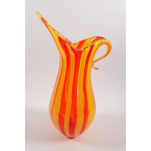 158 - A Murano style hand blown glass candy cane style jug in orange and yellow, 34.5cm tall
