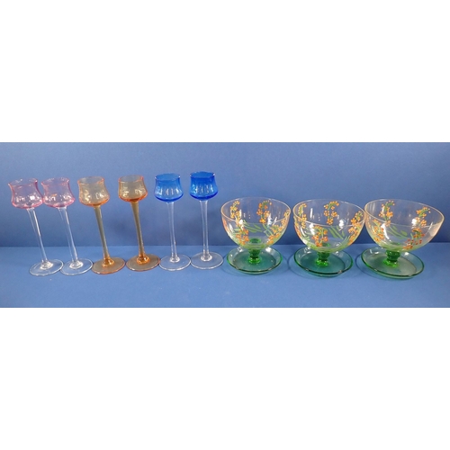 169 - A set of six Harlequin sherry glasses, three floral painted cups, set of four cut glass champagne co... 