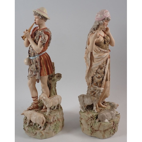18 - A Royal Dux pair of figures of Shepherd and Shepherdess with sheep and goats, both a/f, 38cm high