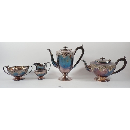 185 - An Art Nouveau silver plated four piece tea service with floral embossed decoration with tea straine... 