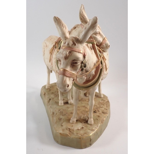 19 - A Royal Dux pair of donkeys wearing tack, 30cm high