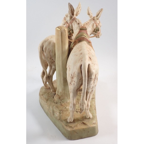 19 - A Royal Dux pair of donkeys wearing tack, 30cm high