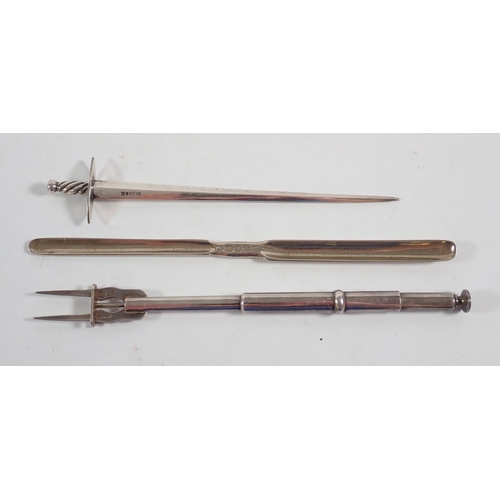 191 - A novetly silver plated book vesta case, sword letter opener, humpty dumpty rattle, marrow scoop and... 