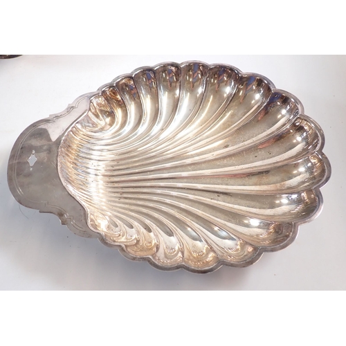 198 - A group of silver plated items including large shell form dish 33cm long, three piece tea set etc.