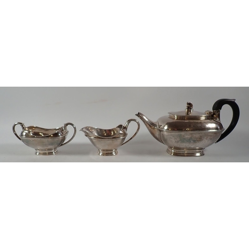 206 - An Omar Ramsden silver three piece Arts & Crafts tea service comprising teapot with kneeling angel f... 