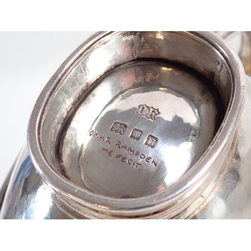 206 - An Omar Ramsden silver three piece Arts & Crafts tea service comprising teapot with kneeling angel f... 