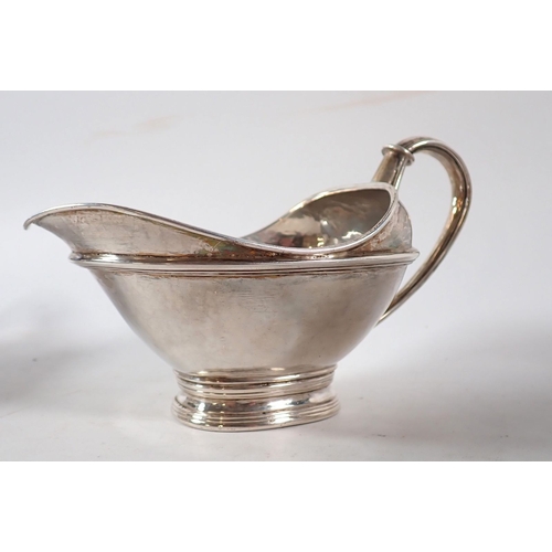 206 - An Omar Ramsden silver three piece Arts & Crafts tea service comprising teapot with kneeling angel f... 