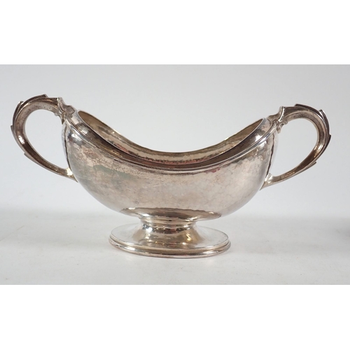 207 - An Omar Ramsden Arts & Crafts silver three piece tea service of naturalistic oval form on pedestal f... 