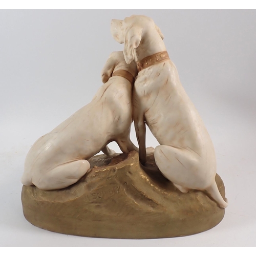 22 - A large Royal Dux group of two hunting dogs tethered together, 30cm high
