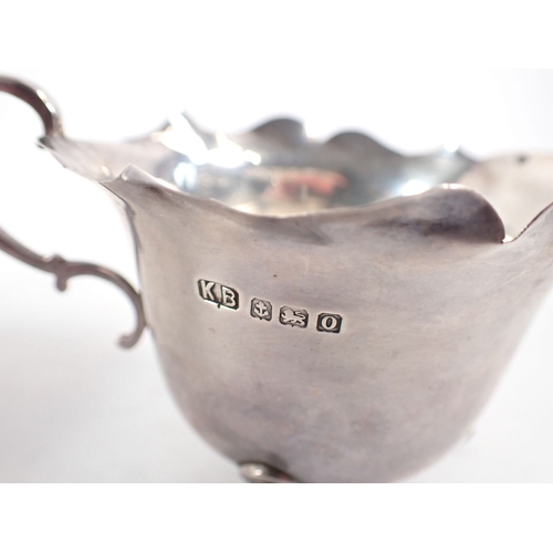 220 - A silver sauce boat, Birmingham 1924 and milk jug with wavy edge, Birmingham 1938, 150g