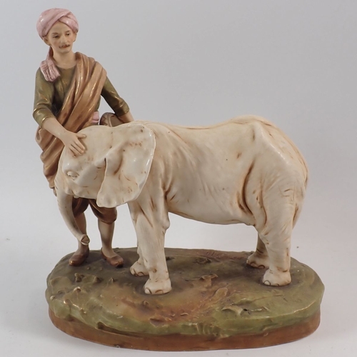 24 - A Royal Dux group of an elephant calf and Mahout, 25cm high