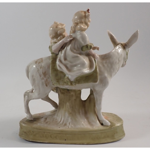 29 - A large porcelain group two children with a donkey, 21cm high