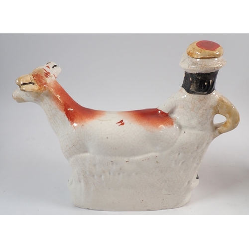 47 - A Staffordshire figure of a gentleman and his dog and a Staffordshire creamer of a farmer and cow - ... 