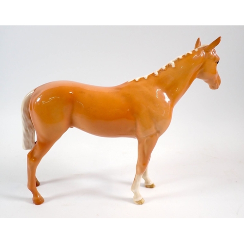 8 - Four Beswick horses - Black Beauty, Palomino and two brown, tallest 21cm high