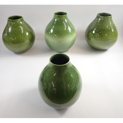 38 - A set of three green pottery vases, 28cm plus a smaller vase
