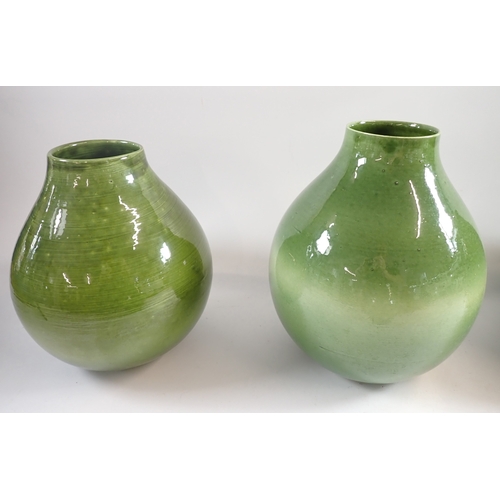 38 - A set of three green pottery vases, 28cm plus a smaller vase