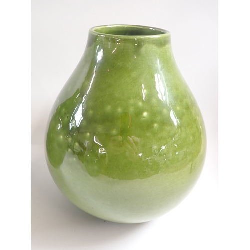 38 - A set of three green pottery vases, 28cm plus a smaller vase