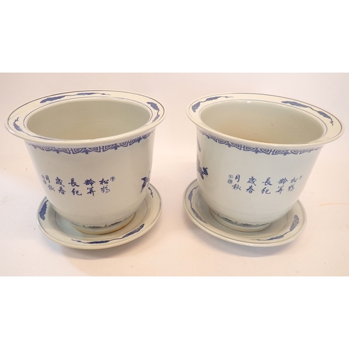 5 - A pair of Chinese blue and white jardinieres decorated cranes each on a Chinese blue and white plate... 