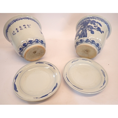 5 - A pair of Chinese blue and white jardinieres decorated cranes each on a Chinese blue and white plate... 