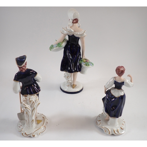 58 - Three Royal Dux figures including flower seller plus a pair of Pierrot salt and peppers, tallest 27c... 