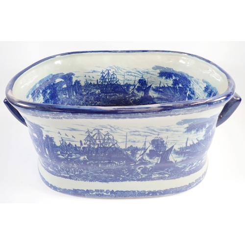25 - Two Victorian blue and white style foot baths, 46cm long, one having handle a/f