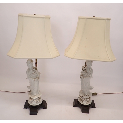 3 - A pair of large Chinese blanc de chine porcelain figurative table lamps and shades, 97cm tall