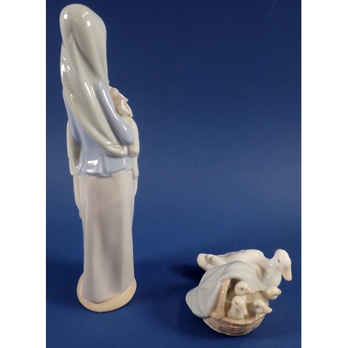 36 - A Lladro figure girl with lilies, 23cm and duck with ducklings
