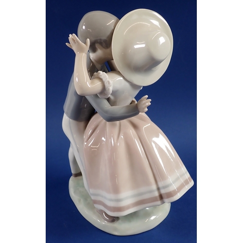 37 - A Lladro group of boy kissing girl, No.856, 24cm - boxed but tatty