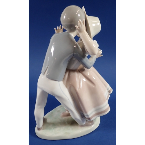 37 - A Lladro group of boy kissing girl, No.856, 24cm - boxed but tatty
