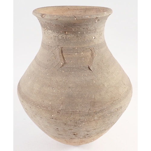 57 - A medieval pottery vase, one handle missing, 26cm tall
