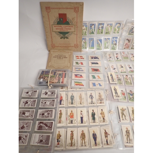 669 - A quantity of cigarette cards and stamps