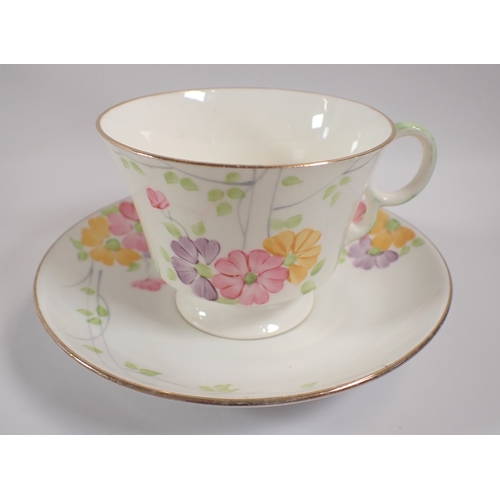 10 - A 1930's floral painted tea service comprising five cups, six saucers, jug and two sugar bowls