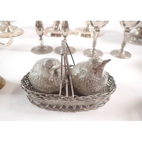 225 - A collection of silver plate, including candlesticks, cruets in the form of chicks, goblets, etc