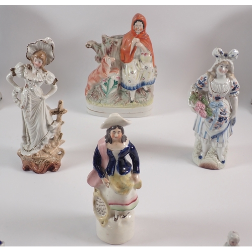 24 - A pair of Victorian Staffordshire dogs, 25cm tall and various Staffordshire groups etc.