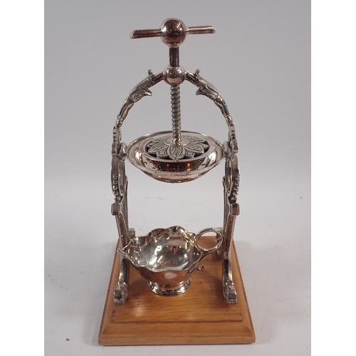 247 - A silver plated lemon squeezer/juicer on wooden base, 26cm tall with silver plated jug