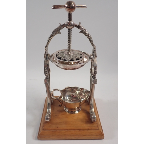 247 - A silver plated lemon squeezer/juicer on wooden base, 26cm tall with silver plated jug