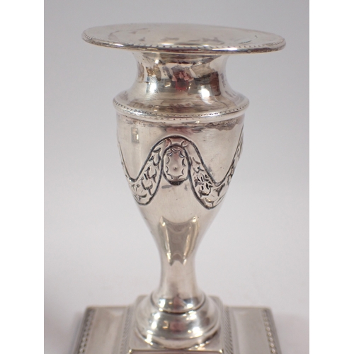 258 - A pair of silver urn form candlesticks with swag decoration, Birmingham 1907 Charles Boyton & Son Lt... 