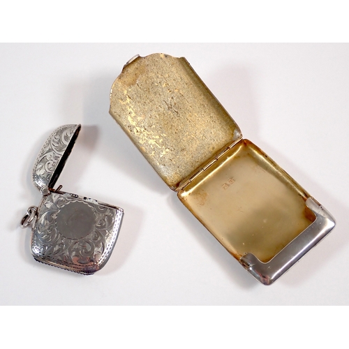 277 - An Edwardian silver vesta case with circular cartouche and engraved scrollwork decoration by William... 