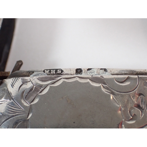 277 - An Edwardian silver vesta case with circular cartouche and engraved scrollwork decoration by William... 
