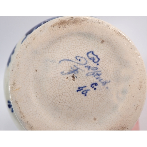 37 - A Delft blue and white jug with bulbous squat body painted flowers and windmill, 17cm tall