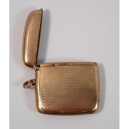 373 - A 9ct gold vesta case with engine turned decoration, London 1924, 4.5cm long, 19g