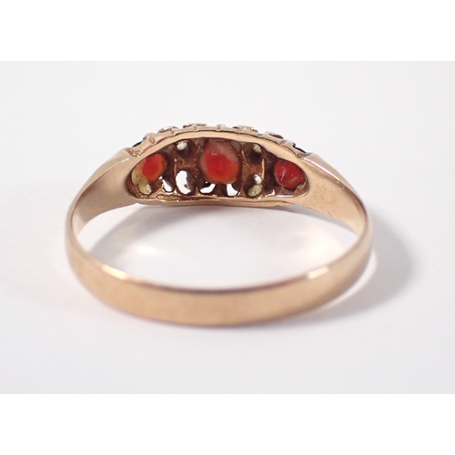 377 - A 9 carat gold three stone garnet ring with diamond accents, one deficient, size T, 2.1g