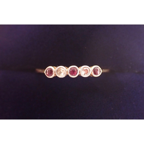 379 - An Edwardian 18ct gold ring set three rubies and two diamonds, size J/K, 1.8g