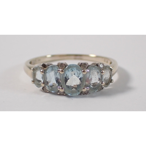 388 - A 9ct gold five stone aquamarine ring with chip diamond accents, size U, 2.7g