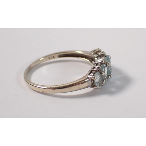 388 - A 9ct gold five stone aquamarine ring with chip diamond accents, size U, 2.7g