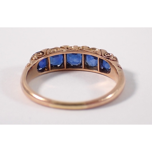 389 - An unmarked gold ring set five sapphires with diamond accents, size Q/R, 3.2g, tested as 9 carat