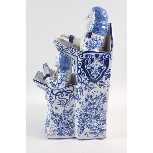 39 - A Delft vicar and Moses group in blue and white, 31cm tall